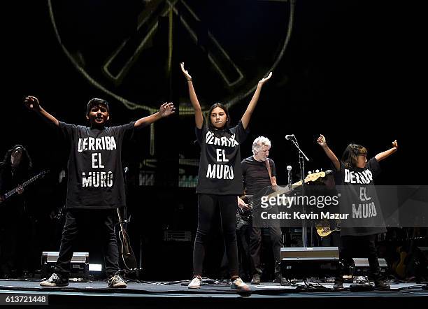 Musician Roger Waters performs with a children's choir wearing a T-shirt saying "derriba el muro" during Desert Trip at The Empire Polo Club on...
