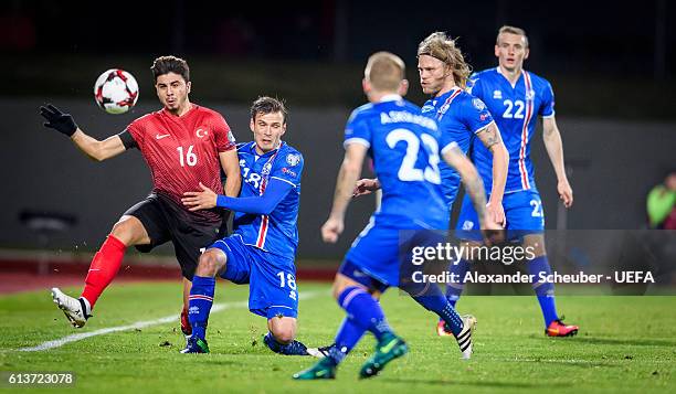 Ozan Tufan of Turkey challenges Elmar Bjarnason of Iceland during the FIFA 2018 World Cup Qualifier between Iceland and Turkey at Laugardalsvoellur...