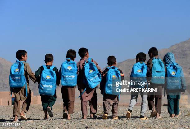 Afghan children walk to school on the outskirts of Herat on October 10, 2016.