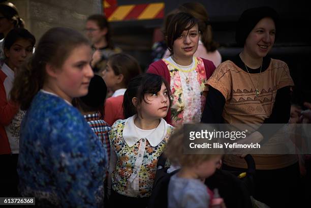 An Ultra-Orthodox Jewish girl watches as men perform the Kaparot ceremony on October 10, 2016 in Jerusalem, Israel. It is believed that the Jewish...