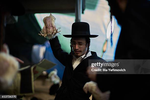 An Ultra-Orthodox Jewish man performs the Kaparot ceremony on October 10, 2016 in Jerusalem, Israel. It is believed that the Jewish ritual, which...