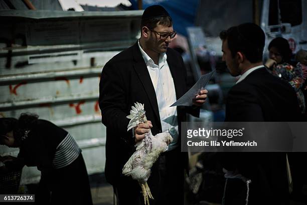 An Ultra-Orthodox Jewish man performs the Kaparot ceremony on October 10, 2016 in Jerusalem, Israel. It is believed that the Jewish ritual, which...