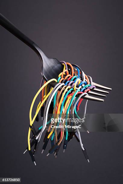Colorful Electric Cables Twisting Around Fork