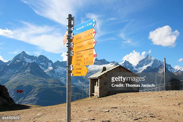 hiking signpost and rotenboden railway station of gornergrat train - summit station stock pictures, royalty-free photos & images