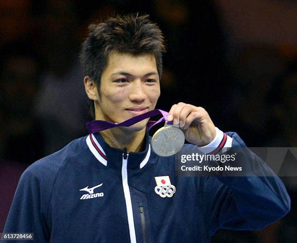 Britain - Japan's Ryota Murata holds up the gold medal he won in the men's middleweight class boxing at the 2012 London Olympics at the ExCeL venue...