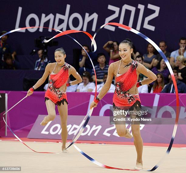 Britain - Japan's Natsuki Fukase and Airi Hatakeyama perform with ribbons during the rhythmic gymnastics team final at the Wembley Arena at the 2012...