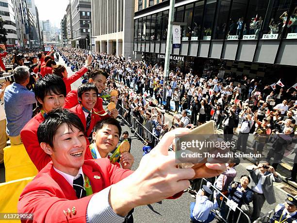 Kohei Uchimura, Koji Yamamuro, Ryohei Kato, Kenzo Shirai, and Yusuke Tanaka take selfies on the double decker bus during the Rio Olympics 2016...