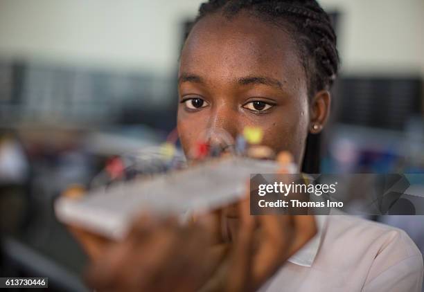 Accra, Ghana Girls Vocational Training Institute, a vocational school where girls are taught in electrical engineering. Here a pupil poses with a...