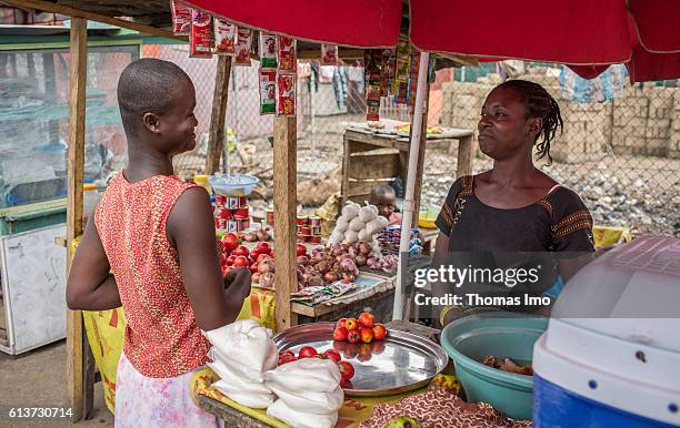 Accra, Ghana A vegetable retailer sells tomatoes to a customer at the market in Accra on September 08, 2016 in Accra, Ghana.