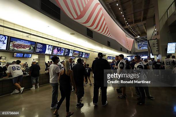 Fans walk the concourse at AT&T Stadium before a game between the Cincinnati Bengals and the Dallas Cowboys on October 9, 2016 in Arlington, Texas.