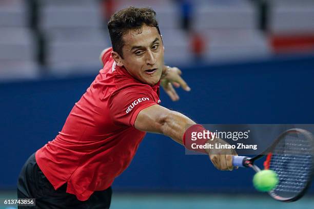 Nicolas Almagro of Spain returns a shot against Mikhail Youzhny of Russia during the Men's singles first round match on day two of Shanghai Rolex...