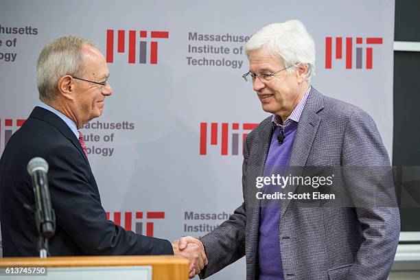 Professor Bengt Holmstrom shakes hands with MIT President L. Rafael Reif before a press conference at MIT announcing his shared Nobel Prize in...