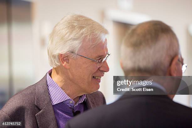 Professor Bengt Holmstrom talks with MIT President L. Rafael Reif before a press conference at MIT announcing his shared Nobel Prize in Economics...