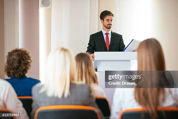 public speaker reading his speech in local assembly - speaker_(politics) stock pictures, royalty-free photos & images