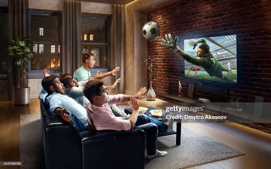 Students watching very realistic Soccer game on TV