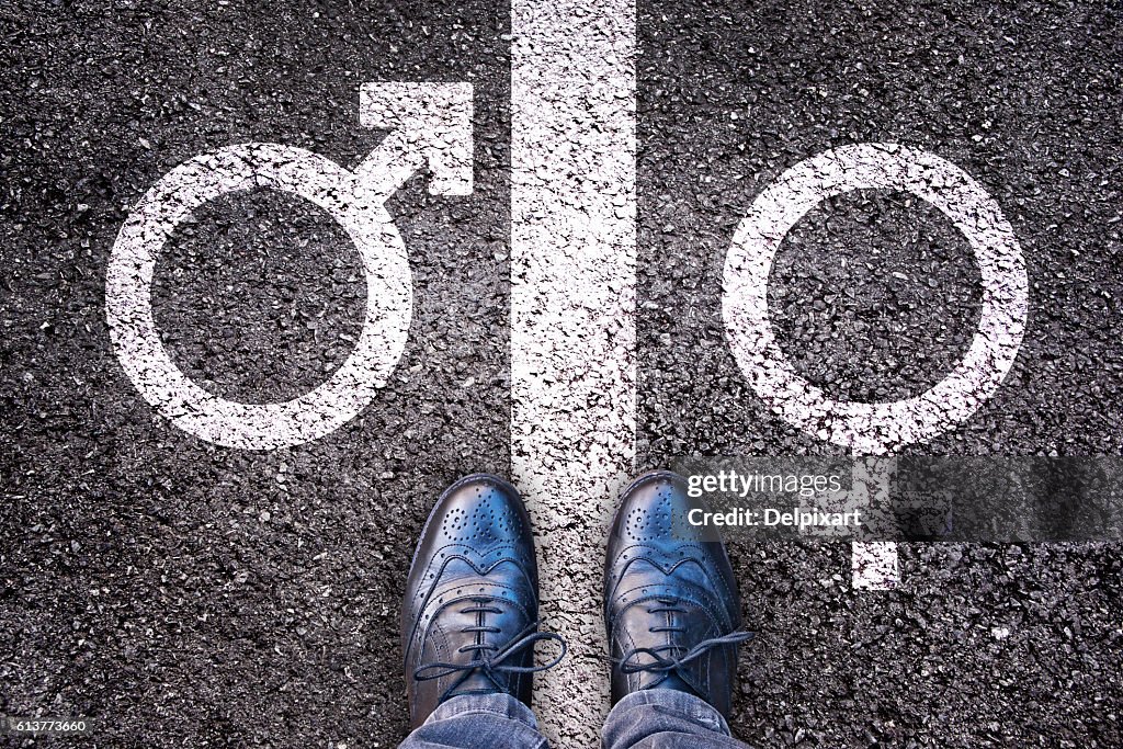 Legs with gender symbol on asphalt, gender concept