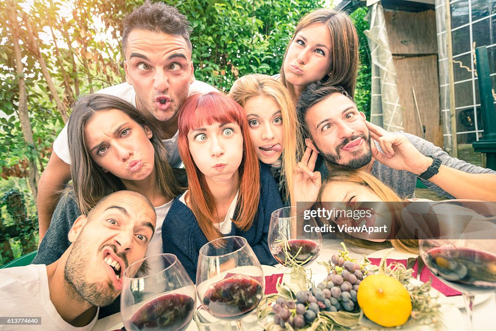 Best friends taking selfie outdoor at winery tasting wine