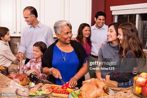 multi-ethnic family cooks thanksgiving, christmas dinner in grandmother's home kitchen. - multi generation family christmas stock pictures, royalty-free photos & images