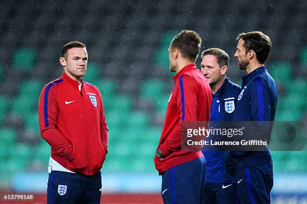 Wayne Rooney of England speaks with Interim Manager Gareth Southgate, first-team coach Steve Holland and Jamie Vardy during a tour of the stadium...