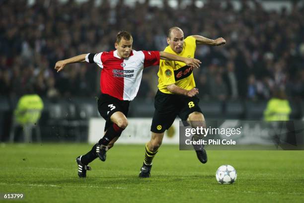 Jan Koller of Borussia Dortmund looks to go past Tomasz Rzasa of Feyenoord during the UEFA Cup Final played at the De Kuip Stadium, in Rotterdam,...