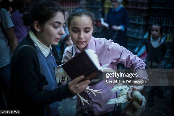 Ultra-Orthodox Jewish girls perform the Kaparot ceremony on October 10, 2016 in Jerusalem, Israel. It is believed that the Jewish ritual, which...