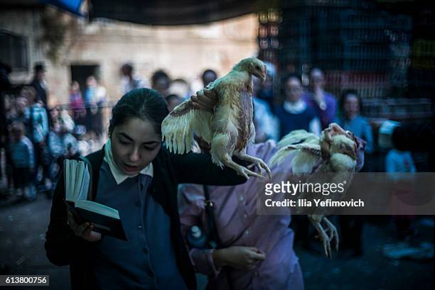 Ultra-Orthodox Jewish girls perform the Kaparot ceremony on October 10, 2016 in Jerusalem, Israel. It is believed that the Jewish ritual, which...