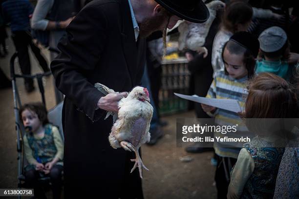 An Ultra-Orthodox Jewish man performs the Kaparot ceremony on October 10, 2016 in Jerusalem, Israel. It is believed that the Jewish ritual, which...