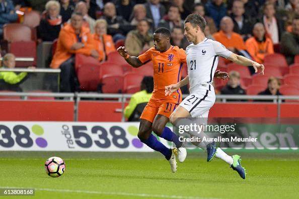 Laurent Koscielny of France and Quincy Promes of The Netherlands