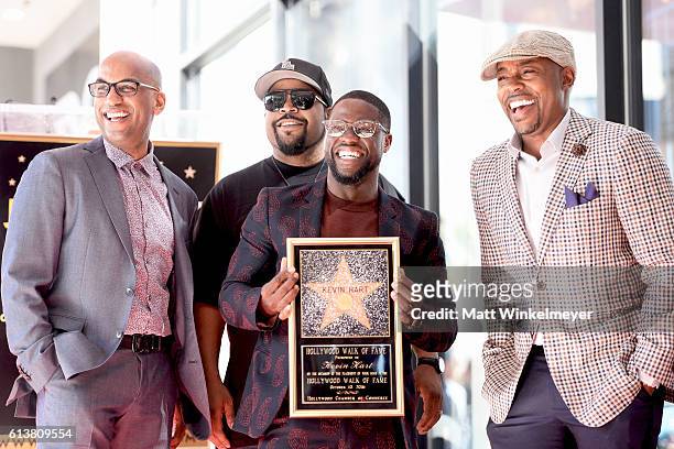 Director Tim Story, rapper/actor Ice Cube, actor/comedian Kevin Hart, and producer Will Packer pose for a photo as Kevin Hart is honored with a star...