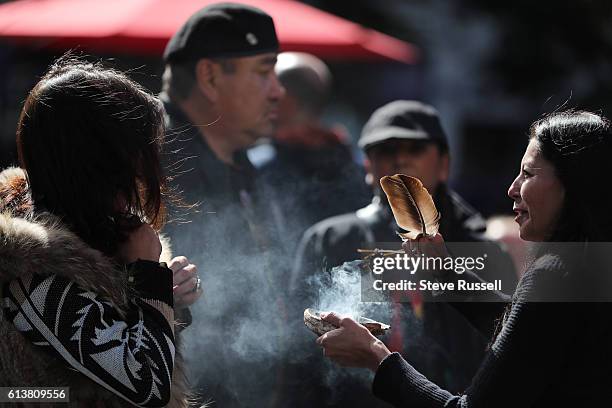 Protesters performed a smudge ceremony with sage from Standing Rock on arrival at Yonge-Dundas Square. The Standing Rock Sioux in the Dakotas are...