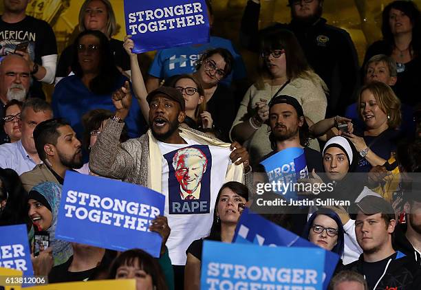 Protester wears a shirt with an image of former U.S. President Bill Clinton and the word 'rape' as democratic presidential nominee former Secretary...