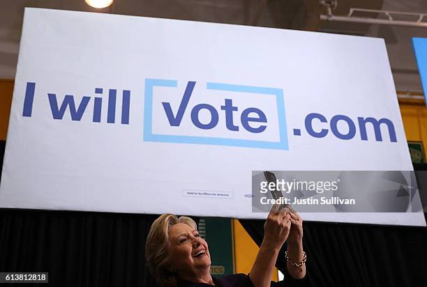 Democratic presidential nominee former Secretary of State Hillary Clinton takes a selfie with supporters during a campaign rally at Wayne State...