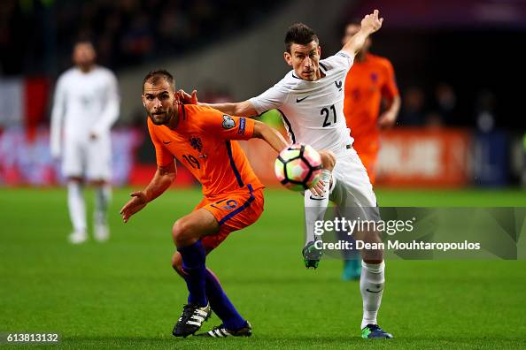 Laurent Koscielny of France and Bas Dost of the Netherlands challenge