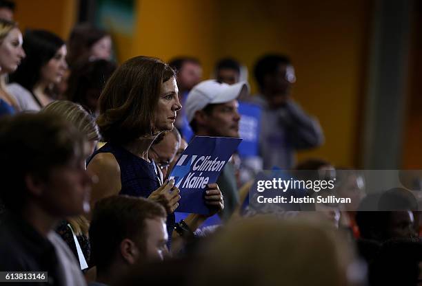 Supporters look on as democratic presidential nominee former Secretary of State Hillary Clinton speaks during a campaign rally at Wayne State...