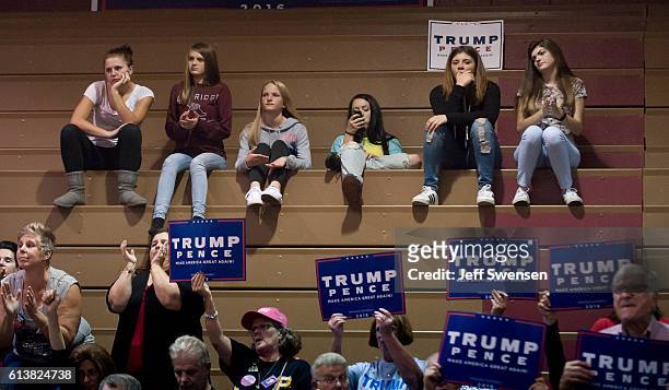 Group of teenagers listens to Republican candidate for President Donald J Trump as he speaks to supporters at a rally at Ambridge Area Senior High...