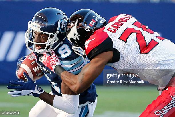 As Calgary Stampeders defensive back Tommie Campbell is about to come crashing in, Toronto Argonauts wide receiver Kenny Shaw looks to gain as much...