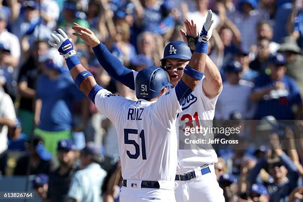 Joc Pederson celebrates with Carlos Ruiz of the Los Angeles Dodgers after Ruiz hits a two-run fifth inning home run against the Washington Nationals...