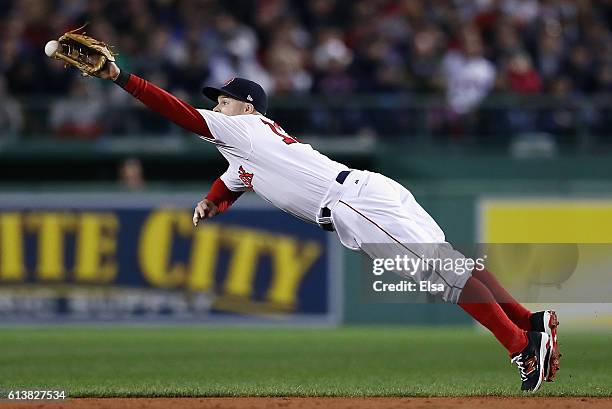 Brock Holt of the Boston Red Sox is unable to catch a ball hit by Lonnie Chisenhall of the Cleveland Indians in the second inning during game three...