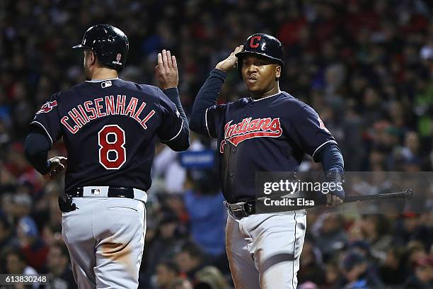 Lonnie Chisenhall of the Cleveland Indians celebrates with Jose Ramirez after they both scored runs on an RBI single hit by Tyler Naquin in the...