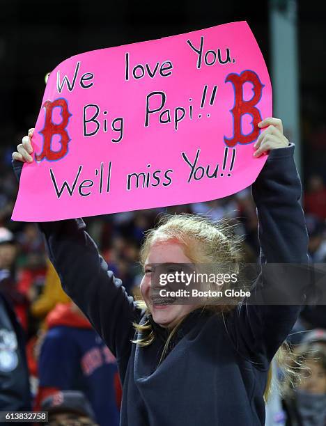 Girl holds a sign in the fifth inning The Boston Red Sox host the Cleveland Indians in Game Three of the American League Division series at Fenway...
