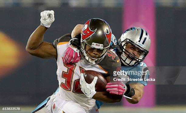 Luke Kuechly of the Carolina Panthers tackles Jacquizz Rodgers of the Tampa Bay Buccaneers in the 1st quarter during their game at Bank of America...