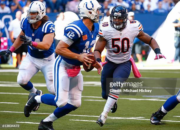 Andrew Luck of the Indianapolis Colts rolls out of the pocket during the game as Jerrell Freeman of the Chicago Bears pursues at Lucas Oil Stadium on...