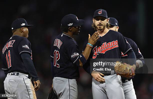 Josh Tomlin of the Cleveland Indians is congratulated by Francisco Lindor as he is relieved in the sixth inning against the Boston Red Sox during...