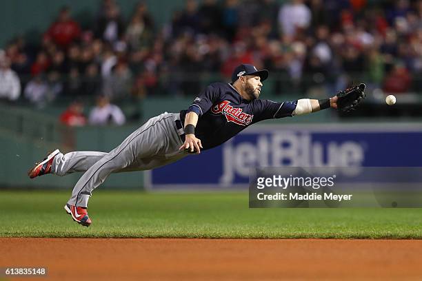 Jason Kipnis of the Cleveland Indians dives for a single hit by Travis Shaw of the Boston Red Sox in the eighth inning during game three of the...