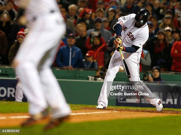 Boston Red Sox designated hitter David Ortiz hits a sacrifice fly to bring in Dustin Pedroia, not pictured, in the sixth inning. The Boston Red Sox...