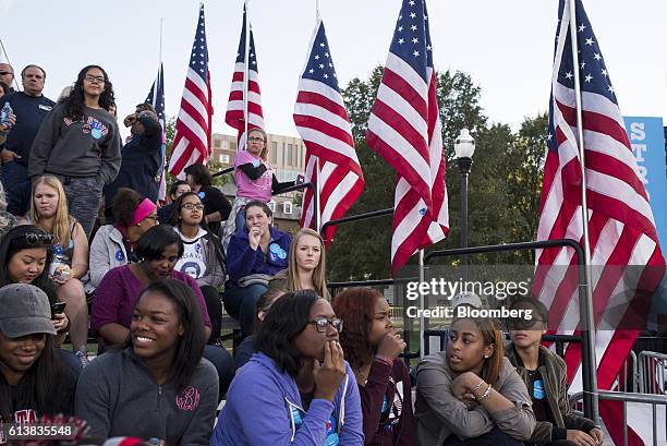 Attendees wait in the stands ahead of a campaign event with Hillary Clinton, 2016 Democratic presidential nominee, in Columbus, Ohio, U.S., on...