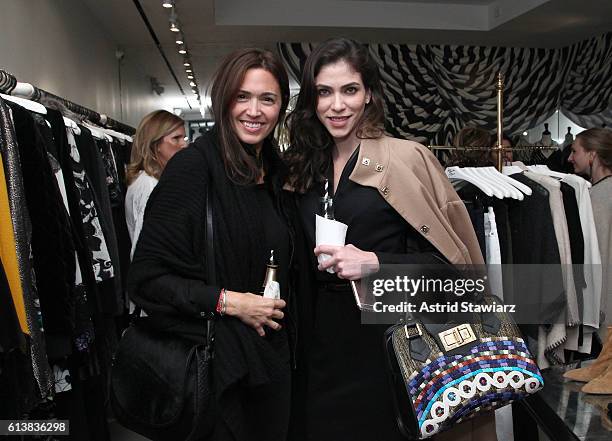 Sara Roter and Alida Boer pose for a photo together as Sara Blakely and Alice + Olivia celebrate the launch of "The Belly Art Project" on October 10,...