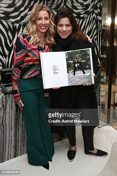 Rachel Goldstein and Sara Blakely pose for a photo together as Sara Blakely and Alice + Olivia celebrate the launch of "The Belly Art Project" on...