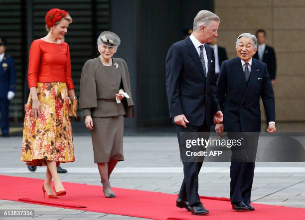 Belgium's King Philippe and Queen Mathilde are escorted by Japan's Emperor Akihito and Empress Michiko on the red carpet during a welcoming ceremony...