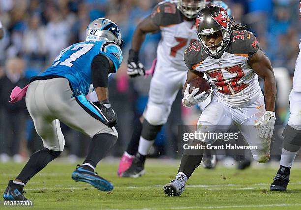 Jacquizz Rodgers of the Tampa Bay Buccaneers runs the ball against Robert McClain of the Carolina Panthers in the 1st quarter during the game at Bank...